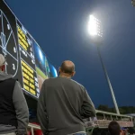 Fans looking at cricket scoreboard